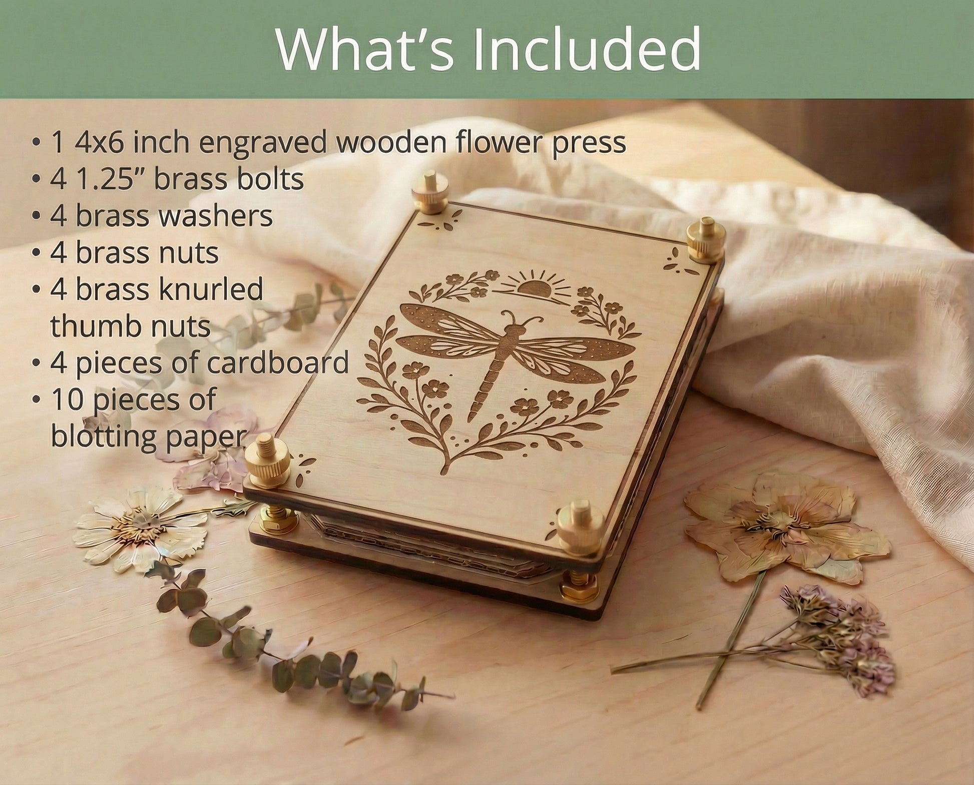 Graphic titled “What’s Included” showing a 4x6 engraved wooden flower press kit with a dragonfly design, listing one 4x6 flower press, four 1.25-inch brass bolts, four brass washers, four brass nuts and four brass knurled thumb nuts, with the assembled maple press styled on a light wood table with dried flowers and eucalyptus.