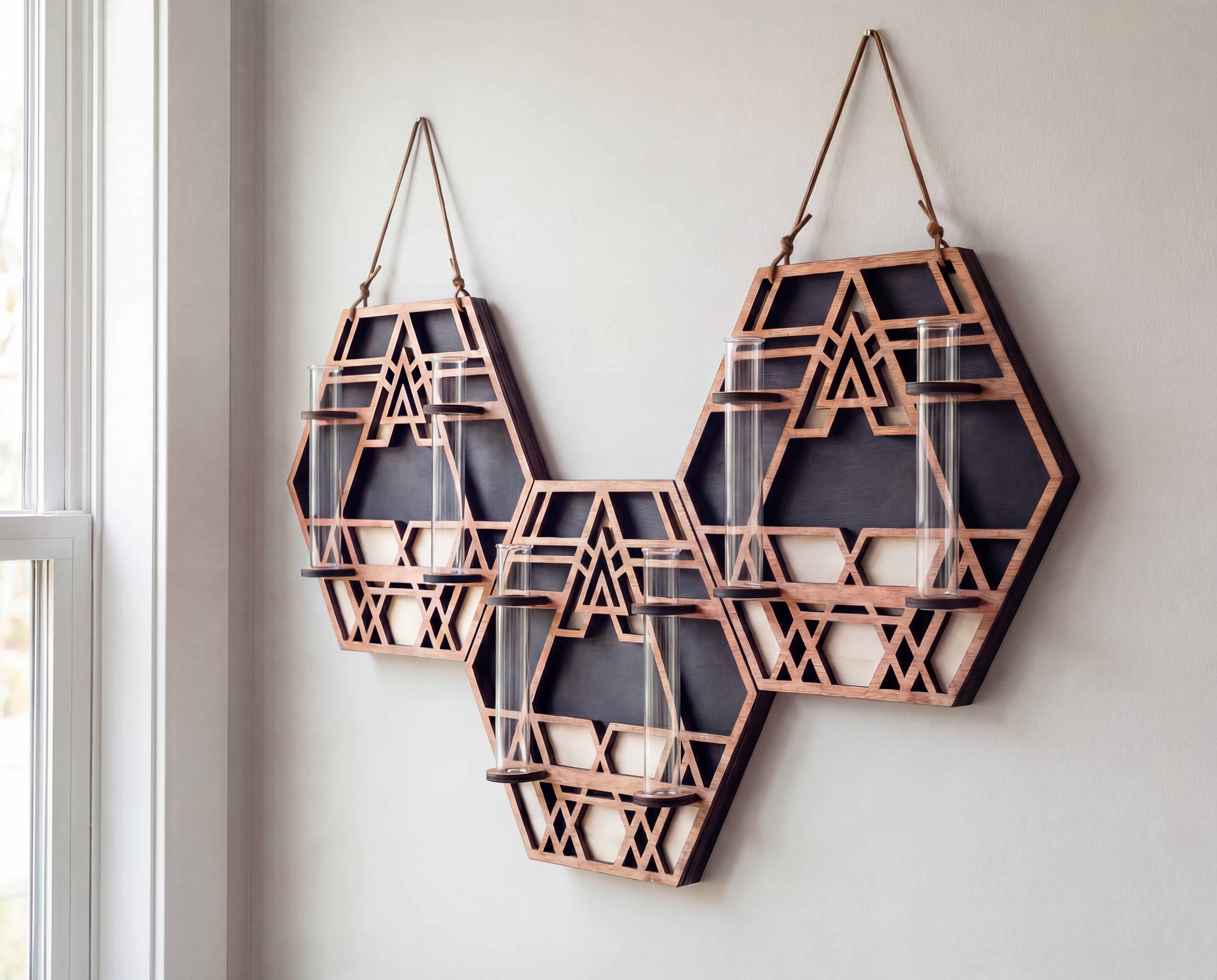 XL trio geometric wall propagation station made from layered maple veneer MDF, featuring three connected hexagon sacred geometry panels with suede hangers and six 6.25-inch by 1-inch glass vials for propagating multiple plant cuttings on a white wall.