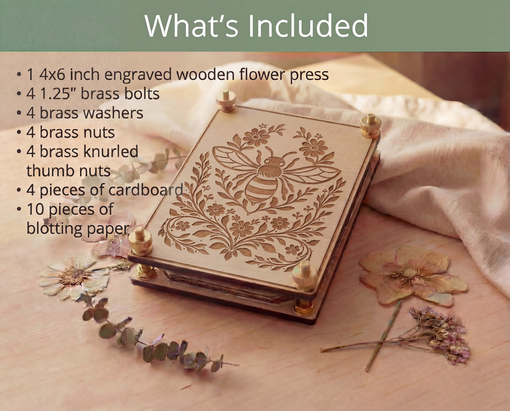 'What’s Included’ graphic for a 4x6 bee engraved wooden flower press kit made from 5.2mm premium maple MDF core board with brass hardware and knurled thumb nuts, listing included components: 4 brass bolts, 4 brass washers, 4 brass nuts, 4 thumb nuts, 4 pieces of cardboard, and 10 sheets of blotting paper, shown styled with pressed flowers and eucalyptus on a light wood surface.